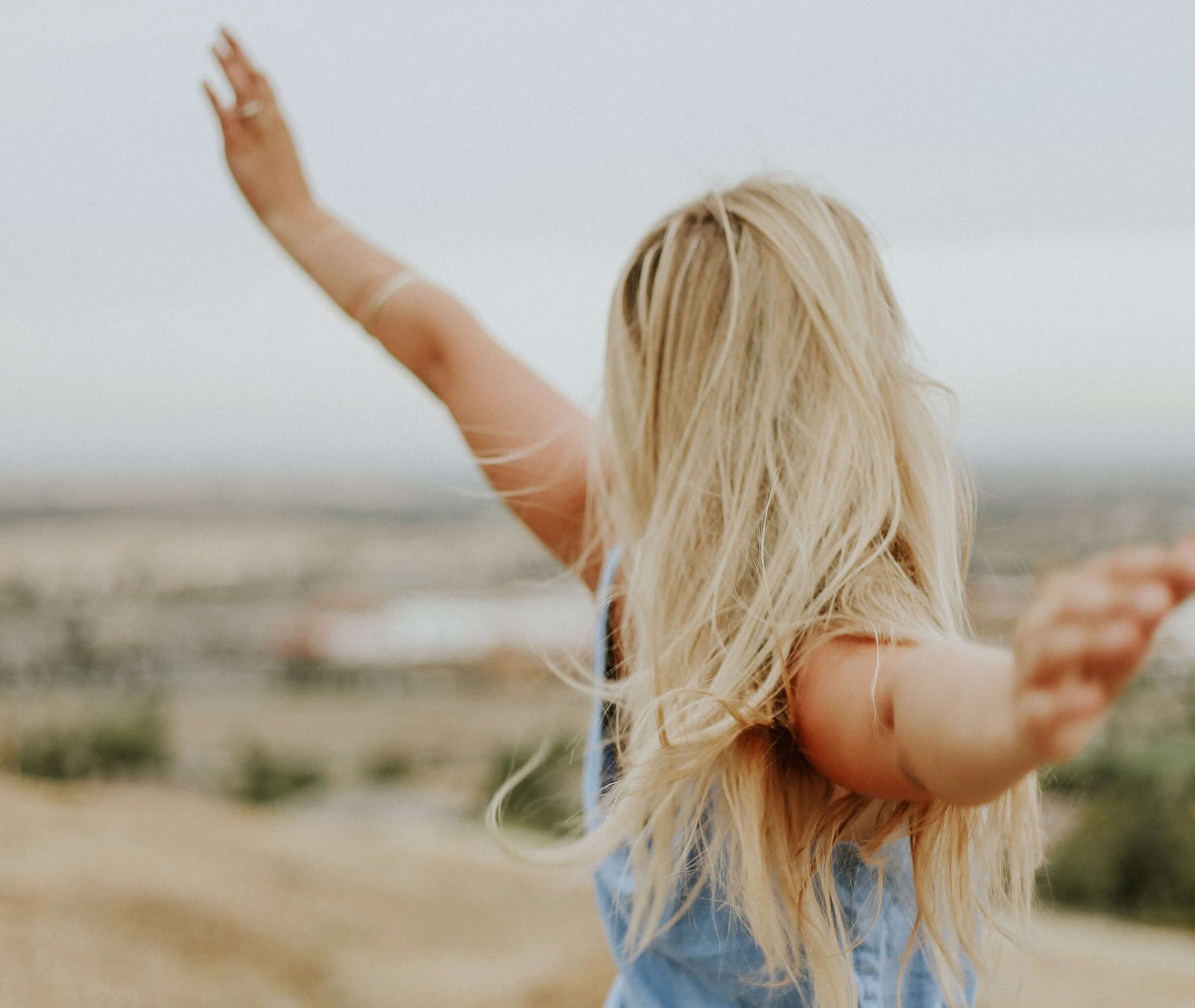 blond women with opened arms