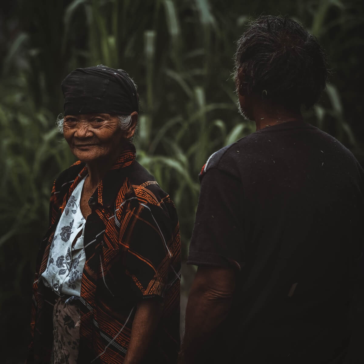 Old balinese woman and man in a ricefield