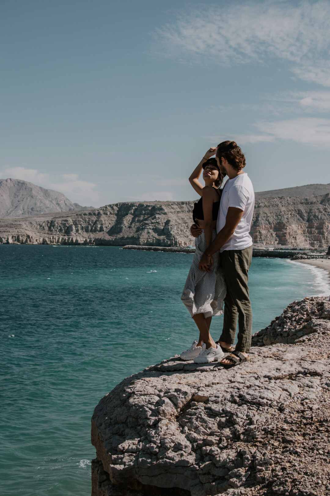 Pili and Dano on a cliff next to the camping beach