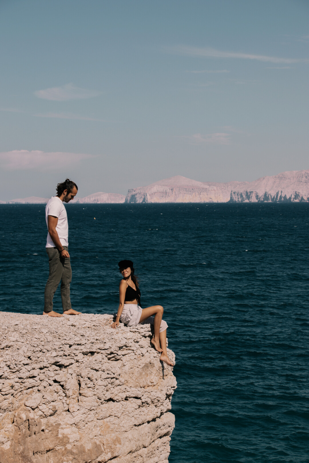 Pili and Dano next to a cliff in Musandam