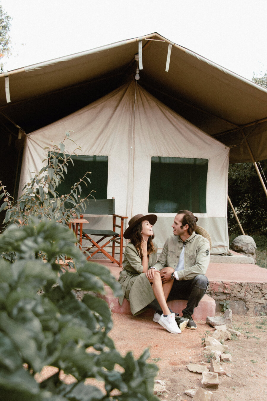 Pili and Dano sitting in front of their tent in the tented camp in the Masai Mara