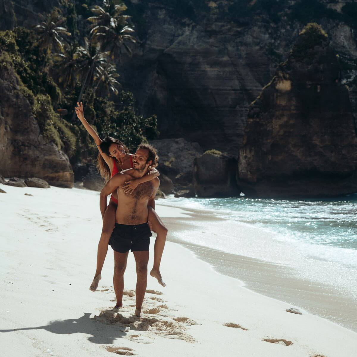 couple in a beach alone. Man carrying women
