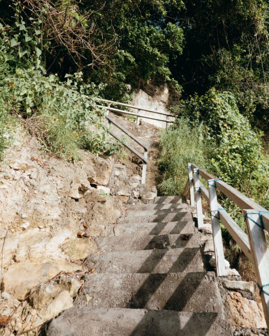 man build staircase in Suwehan beach, Nusa Penida, Bali