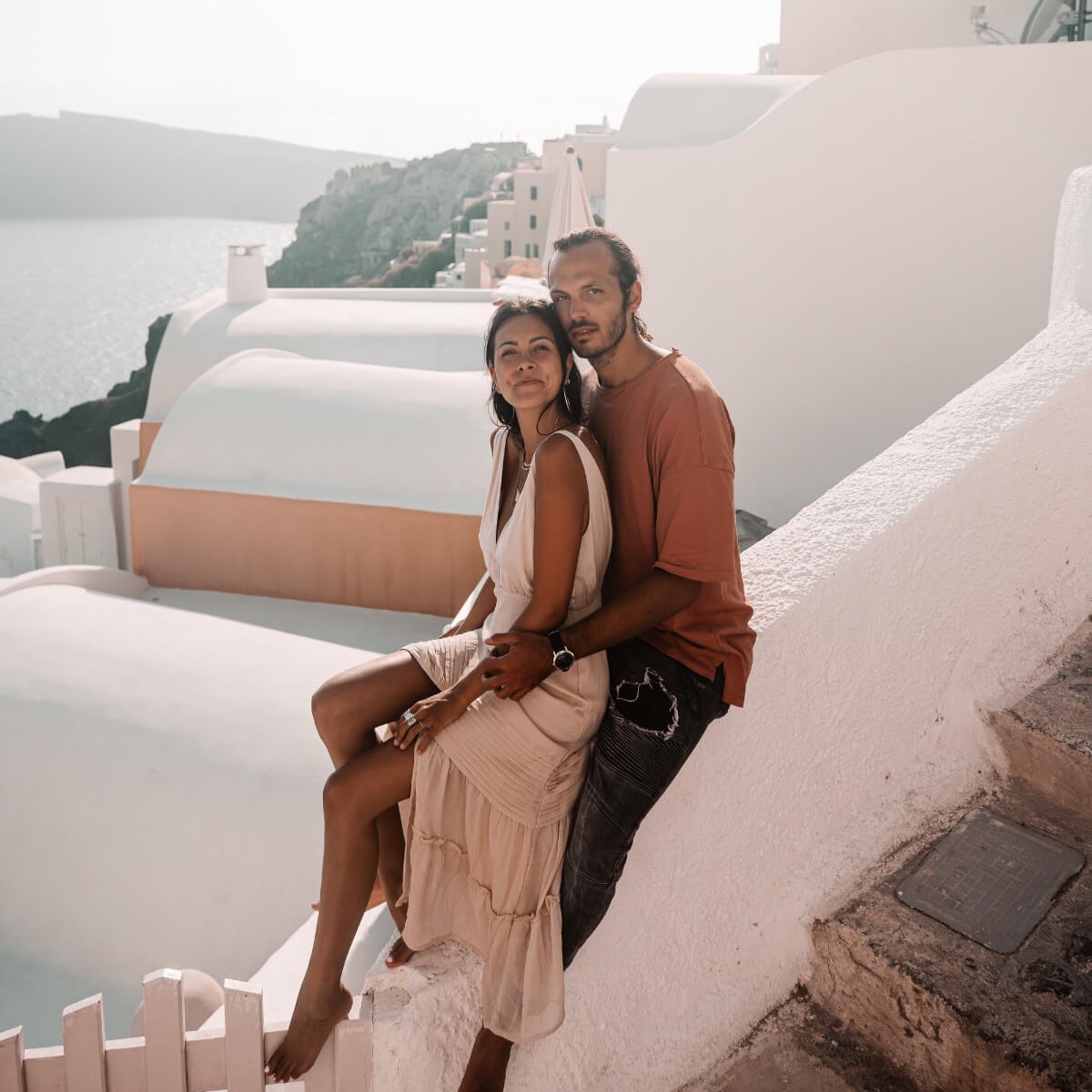 couple sitting together in Santorini Greece